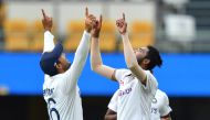 Mohammed Siraj of India celebrates with Mayank Agarwal after getting the wicket of Josh Hazlewood of Australia during day four of the fourth test match between Australia and India at the Gabba in Brisbane, Australia, January 18, 2021. AAP Image/Darren Eng