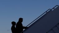 U.S. President Donald Trump departs next to first lady Melania Trump from the Joint Base Andrews, Maryland, U.S., January 20, 2021. REUTERS/Carlos Barria