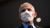 FILE PHOTO: Dr. Anthony Fauci, director of the National Institute of Allergy and Infectious Diseases, speaks with Health and Human Services Secretary Alex Azar before receiving his first dose of the new Moderna COVID-19 vaccine at the National Institutes 
