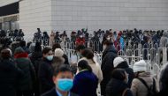 People line up to get their nucleic acid test at a mass testing site following the outbreak of the coronavirus disease (COVID-19) in Beijing, China, January 22, 2021. REUTERS/Thomas Peter