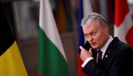 Lithuanian President Gitanas Nauseda takes off his mask as he arrives for a European Union summit during the coronavirus lockdown in Brussels, Belgium, December 10, 2020. John Thys/Pool via REUTERS/File Photo