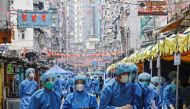 Health workers are seen in protective gear inside a locked down portion of the Jordan residential area to contain a new outbreak of the coronavirus disease (COVID-19), in Hong Kong, China January 23, 2021. REUTERS/Tyrone Siu TPX IMAGES OF THE DAY
