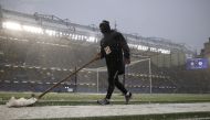 January 24, 2021 A member of groundstaff clears snow from the side of the pitch before the match Action Images via Reuters/John Sibley