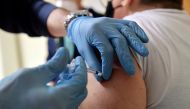A volunteer who assists medical workers receives a dose of the Moderna coronavirus disease (COVID-19) vaccine at the Misericordia hospital in Grosseto, Italy, January 18, 2021. REUTERS/Jennifer Lorenzini
