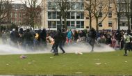 Police uses a water canon during a protest against restrictions put in place to curb the spread of the coronavirus disease (COVID-19), in Amsterdam, Netherlands January 24, 2021. REUTERS/Eva Plevier

