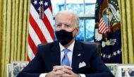 FILE PHOTO: U.S. President Joe Biden signs executive orders in the Oval Office of the White House in Washington, after his inauguration as the 46th President of the United States, U.S., January 20, 2021. REUTERS/Tom Brenner/File Photo
