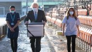 British Prime Minister Boris Johnson loads doses of the Oxford/AstraZeneca COVID-19 vaccine for mobile distribution at Barnet FC's ground, The Hive, which is being used as a coronavirus vaccination centre, in north London, Britain January 25, 2021. Stefan