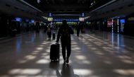 People walk in the Beijing West railway station ahead of upcoming Chinese New Year celebrations following an outbreak of the coronavirus disease (COVID-19) in Beijing, China, January 27, 2021. REUTERS/Thomas Peter