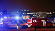 Medical personnel stand next to ambulances with COVID-19 patients as they wait in the queue at Santa Maria hospital, amid the coronavirus disease (COVID-19) pandemic in Lisbon, Portugal, January 27, 2021. REUTERS/Pedro Nunes
