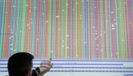 A scientist at Bioscientia laboratories points at a sequenced and analysed mutant version of the coronavirus, as the spread of COVID-19 continues, at the Bioscientia headquarters in Ingelheim, Germany, January 27, 2021. REUTERS/Kai Pfaffenbach
