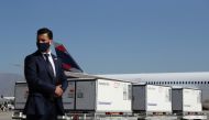 A plainclothes police stands guard next to containers transporting the first batch of the Sinovac's COVID-19 vaccine at the International airport of Santiago, as the coronavirus disease (COVID-19) outbreak continues, Chile, January 28, 2021. REUTERS/Ivan 