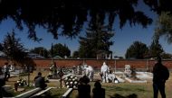 Family members look as cemetery workers bury the body, who died from the coronavirus disease (COVID-19), on the outskirts of Mexico City, Mexico January 25, 2021. REUTERS/Carlos Jasso
