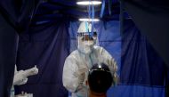 A doctor collects a swab sample from a man at a testing station of Clinic 365, amid the coronavirus disease (COVID-19) outbreak in Kuala Lumpur, Malaysia January 29, 2021. REUTERS/Lim Huey Teng