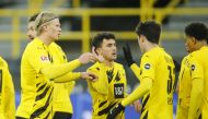 Borussia Dortmund's Erling Braut Haaland and teammates celebrate after FC Augsburg's Felix Uduokhai scored Borussia Dortmund 's third with an own goal Pool via REUTERS/Leon Kuegeler 