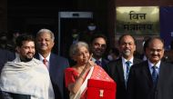 India's Finance Minister Nirmala Sitharaman stands next to Minister of State for Finance and Corporate Affairs Anurag Thakur (L) as she leaves her office to present the federal budget in the parliament in New Delhi, India, February 1, 2021. Reuters/Anushr