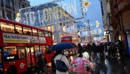 FILE PHOTO: People hold umbrellas as they walk, following the outbreak of the coronavirus disease (COVID-19), in London, Britain December 16, 2020. REUTERS/Toby Melville

