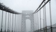 Cars pass over the George Washington Bridge in heavy falling snow between New Jersey and New York City during a winter storm in New York, U.S., February 1, 2021. REUTERS/Mike Segar
