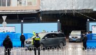 Cars carrying members of the World Health Organization (WHO) team tasked with investigating the origins of the coronavirus disease (COVID-19) leave Huanan seafood market in Wuhan, Hubei province, China January 31, 2021. REUTERS/Thomas Peter
