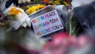 Flowers and notes are seen near the residence of Captain Sir Tom Moore, after his family announced that the centenarian fundraiser died, in Marston Moretaine near Milton Keynes, Britain February 3, 2021. REUTERS/Hannah McKay