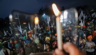 Farmers take part in a candlelit vigil, in memory of a person who died during a tractor rally on India’s Republic Day, as protests against farm laws continue, at Singhu Border near New Delhi, India, February 4, 2021. REUTERS/Anushree Fadnavis
