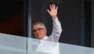 Dominic Dwyer, a member of the World Health Organization (WHO) team tasked with investigating the origins of the coronavirus disease (COVID-19), waves from a balcony at a hotel in Wuhan, Hubei province, China January 29, 2021. Picture taken January 29, 20