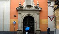 A man shelters from the rain underneath a blue umbrella during the coronavirus disease (COVID-19) outbreak in Madrid, Spain, February 2, 2021. REUTERS/Susana Vera