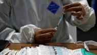 A healthcare worker prepares a dose of Sinovac's vaccine for the coronavirus disease (COVID-19) during a mass vaccination for medical workers at the Istora Senayan stadium in Jakarta, Indonesia, February 4, 2021. REUTERS/Willy Kurniawan