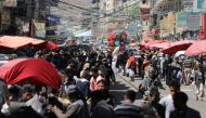 People walk at a street market in Sanaa, Yemen February 5, 2021. Reuters/Khaled Abdullah
