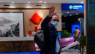 Peter Ben Embarek, a member of the World Health Organisation (WHO) team tasked with investigating the origins of the coronavirus disease (COVID-19), waves as he arrives at the airport to leave Wuhan, Hubei province, China February 10, 2021. REUTERS/Aly So