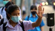 A student wearing a face mask undergoes a temperature check to prevent the spread of the coronavirus disease (COVID-19), as schools nationwide reopened in Bangkok, Thailand, February 1. 2021. REUTERS/Athit Perawongmetha/File Photo