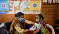 A health care worker receives a dose of COVISHIELD, a COVID-19 vaccine manufactured by Serum Institute of India, inside a classroom of school, which has been converted into a temporary vaccination centre, in Ahmedabad, India, February 9, 2021. REUTERS/Ami