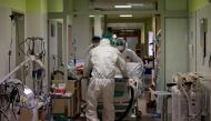 Members of the medical staff transfer a patient suffering from coronavirus disease (COVID-19) from a fully occupied Intensive Care Unit (ICU) of the Nachod hospital, Czech Republic February 11, 2021. Picture taken February 11, 2021. REUTERS/David W Cerny