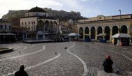 People sit in Monastiraki square after the Greek government imposed stricter lockdown measures against the coronavirus pandemic, in Athens, Greece, February 11, 2021. REUTERS/Alkis Konstantinidis/File Photo