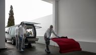 Funeral workers prepare for a farewell ceremony for a person who died from the coronavirus disease (COVID-19) at Alcabideche crematorium during the COVID-19 pandemic in Cascais, Portugal, February 9, 2021. Picture taken February 9, 2021. REUTERS/Pedro Nun