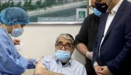Salah Tizani, 92, known as Abou Salim and one of Lebanon's first TV celebrities, receives a dose of the Pfizer/BioNTech vaccine against the coronavirus disease (COVID-19) during a coronavirus vaccination campaign at Rafik Hariri University Hospital, in Be
