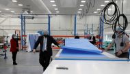 Britain's Prime Minister Boris Johnson, wearing a face mask to prevent the spread of the coronavirus disease (COVID-19), visits a PPE manufacturing facility, in Seaton Delaval, Britain, February 13, 2021. Scott Heppell/Pool via REUTERS