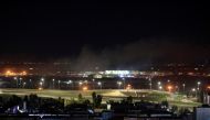 Smoke rises over the Erbil, after reports of mortar shells landing near Erbil airport, Iraq February 15, 2021. REUTERS/Thaier al-Sudani