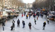 People ice skate during a cold snap across the country at the Prinsengracht in Amsterdam, Netherlands February 14, 2021. REUTERS/Eva Plevier
