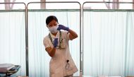 A medical worker fills a syringe with a dose of the Pfizer-BioNTech coronavirus disease (COVID-19) vaccine as Japan launches its inoculation campaign, at Tokyo Medical Center in Tokyo, Japan February 17, 2021. Behrouz Mehri/Pool via REUTERS