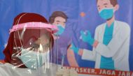 A health care worker prepares a dose of China's Sinovac Biotech vaccine for the coronavirus disease (COVID-19), during a mass vaccination for vendors at the Tanah Abang textile market in Jakarta, Indonesia, February 17, 2021. Reuters/Ajeng Dinar Ulfiana