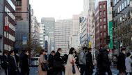 FILE PHOTO: Pedestrians wearing protective masks, following the coronavirus disease (COVID-19) outbreak, make their way during commuting hour at a business district in Tokyo, Japan, January 7, 2021. REUTERS/Kim Kyung-Hoon/File Photo GLOBAL BUSINESS WEEK A