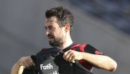 Eintracht Frankfurt's Amin Younes holds up a shirt to commemorate a victim of the shooting in Hanau on February 19, 2020, prior to the Bundesliga match Pool via REUTERS/Daniel Roland 