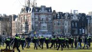 FILE PHOTO: Police officers are seen, as people protest against the coronavirus disease (COVID-19) restrictions in Amsterdam, Netherlands, February 21, 2021. REUTERS/Piroschka van de Wouw/File Photo
