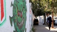 A coronavirus-themed mural is seen on a wall amid the coronavirus disease (COVID-19) outbreak, in Gaza City, February 16, 2021. REUTERS/Mohammed Salem
