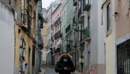 FILE PHOTO: A person wearing a protective mask walks in Bairro Alto neighborhood during the national lockdown, amid the coronavirus disease (COVID-19) pandemic, in Lisbon, Portugal, January 23, 2021. REUTERS/Pedro Nunes/File Photo
