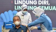 Malaysia's Prime Minister Muhyiddin Yassin receives the first dose of Pfizer-BioNTech COVID-19 vaccine at a clinic in Putrajaya, Malaysia February 24, 2021. Malaysia's Information Department/Muzzafar Kasim/Handout via REUTERS