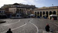 People sit in Monastiraki square after the Greek government imposed stricter lockdown measures against the coronavirus pandemic, in Athens, Greece, February 11, 2021. REUTERS/Alkis Konstantinidis/File Photo