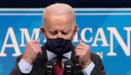 U.S. President Joe Biden removes his face mask as he arrives to announce changes to the main U.S. coronavirus disease (COVID-19) aid program for small businesses during brief remarks in the South Court Auditorium at the White House in Washington, U.S., Fe