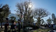 Members of the media are seen outside the Harbor-UCLA Medical Center in Torrance, California, U.S., where golfer Tiger Woods was taken to following a car crash, February 23, 2021. REUTERS/Mike Blake