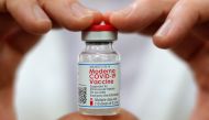 Walmart pharmacist Carmine Pascarella holds a vial of the Moderna coronavirus disease (COVID-19) vaccine inside a Walmart department store as Walmart and other major U.S. pharmacies take part in the Federal Retail Pharmacy Program, to increase vaccination